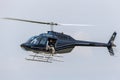 Bell 206B-3 Helicopter G-XBOX being used by a photographer to take aerial photos