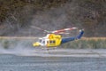 Bell 412 helicopter filling with water to fight a bushfire