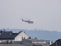 Bell 412 helicopter of the Government of Spain flying over the buildings of the city of Monforte during the fire season in Galicia Royalty Free Stock Photo