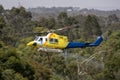 Bell 412 helicopter taking off after filling with a load of water