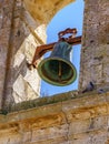 Bell in medieval stone church tower with blue sky. Europe Royalty Free Stock Photo