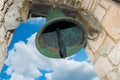 Bell in old colonial church. Ancient village Altos de Chavon - Colonial town reconstructed in Dominican Republic