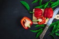 Bell pepper cut in half on a wooden cutting board on a black background. Royalty Free Stock Photo