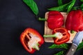 Bell pepper cut in half on a wooden cutting board on a black background. Royalty Free Stock Photo