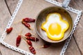 Bell pepper egg ring on a cooking pan and dried chili peppers Royalty Free Stock Photo