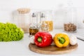 bell pepper, mushrooms and lettuce on wooden board in kitchen