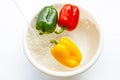 Bell pepper soaked in water. Washing fresh vegetables on white