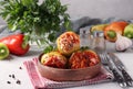 Bell Pepper Stuffed with rice and minced beef in tomato sauce in a plate on light gray background Royalty Free Stock Photo