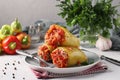 Bell Pepper Stuffed with rice and minced beef in tomato sauce in a plate on light gray background, Closeup Royalty Free Stock Photo