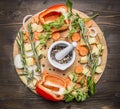 Bell peppers, various unground pepper, chopped carrots, potatoes and herbs on a cutting board wooden rustic background top view Royalty Free Stock Photo