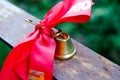 Bell with a ribbon. Last call. A bell with a red ribbon. Spring holiday. School years. Graduation. School bells on the background