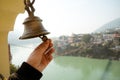 Bell in Tera Manzil Temple. Rishikesh. India. ringing of the bell in the temple. the hand holds the bell