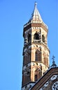 Bell tower of the Basilica del Santo in Padua, illuminated by the sun, close to sunset and silhouetted in the blue sky.