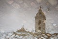 Bell tower of the Basilica of Our Lady of Pillar reflected in a puddle of water Royalty Free Stock Photo