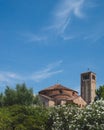 Bell tower of Cathedral of Santa Maria Assunta and Church of Santa Fosca over trees in Torcello, Venice, Italy Royalty Free Stock Photo