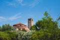 Bell tower of Cathedral of Santa Maria Assunta and Church of Santa Fosca over trees in Torcello, Venice, Italy Royalty Free Stock Photo