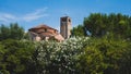 Bell tower of Cathedral of Santa Maria Assunta and Church of Santa Fosca over trees in Torcello, Venice, Italy Royalty Free Stock Photo