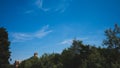 Bell tower of Cathedral of Santa Maria Assunta over buildings and trees in Torcello, Venice, Italy Royalty Free Stock Photo