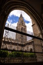 Bell tower of the Cathedral of Toledo seen through an arch of the cloister, Spain