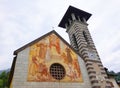 The Bell Tower and the Church of Madonna dell`Aiuto, in Fiera di Primiero. Royalty Free Stock Photo