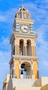 Bell tower with clock of Catholic Cathedral Church of Saint John the Baptist in Fira on Santorini island, Cyclades, Greece Royalty Free Stock Photo