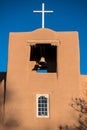 Bell tower and cross on an historic adobe Spanish mission church in the American Southwest Royalty Free Stock Photo