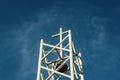 Bell Tower with Cross at Top Against a Blue Sky Royalty Free Stock Photo