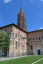 Bell tower and distinctive red brick exterior of the Basilica of Saint-Sernin, Toulouse, France Royalty Free Stock Photo