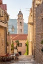 Bell tower of Dominican Monastery view from Dubrovnik old town street in Croatia summer morning