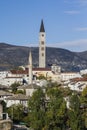 The bell tower of the Franciscan monastery over the roofs of dwelling houses in the town of Mostar. Bosnia and Herzegovina Royalty Free Stock Photo