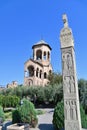 Bell Tower and Georgian Carved Pillar at Holy Trinity Cathedral of Tbilisi Royalty Free Stock Photo