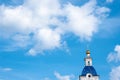 Bell tower with a golden dome and a cross against a blue sky Royalty Free Stock Photo