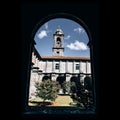 Bell tower of the Monastery of Armenteira seen through an arch. Spain.