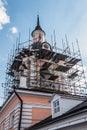 Bell tower of the old Church in the scaffolding for restoration Royalty Free Stock Photo
