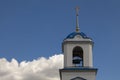 The bell tower of an old Orthodox church against a blue sky with white clouds Royalty Free Stock Photo