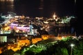 Bell tower of the Old Town of Budva city and Ricardova Glava beach at night time. Aerial view with houses roofs. Adriatic sea. Royalty Free Stock Photo