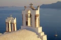 Bell tower of old white church above the beautiful blue sea, Oia Royalty Free Stock Photo