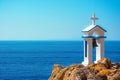 Bell tower of an orthodox church with blue sea for background at Loutro, Chania, Crete. Royalty Free Stock Photo