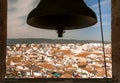 Bell of tower over cityscape of Cordoba with white houses, Spain