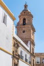 Bell tower and perspective of Santo Domingo convent with pediment and religious statue above the entrance door, CÃ¡diz SPAIN