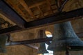 Bell tower roof with wooden and iron beams with three restored bronze bells from the bell tower of the Clerecia church in