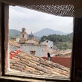 Bell tower and several town houses seen through the window Royalty Free Stock Photo