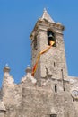 Bell tower in Spanish village with sunny day on hanging flag Royalty Free Stock Photo