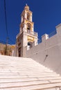 Bell tower of a traditional Greek Orthodox church on a narrow street of Symi island Royalty Free Stock Photo