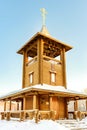 Bell tower wooden church of logs in winter Royalty Free Stock Photo