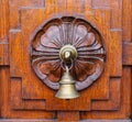 A bell on wooden door at Old Town in Penang, Malaysia Royalty Free Stock Photo