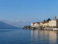 Bellagio, Italy  March 30 2019 View of Bellagio town  from Lake Como with the mountains as background with some snow in early Royalty Free Stock Photo