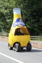 Orangina bottle vehicle during the passing of the publicity caravan on the road during Le Tour de France on July