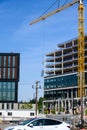 BELLEVUE, USA â MAY 3, 2023: Spring District, under construction, crane loading in new window to workers ready to install