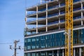 BELLEVUE, USA â MAY 3, 2023: Spring District, under construction, crane loading in new window to workers ready to install